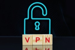 Acronym VPN (Virtual Private Network) made of wooden cubes on dark background with lock