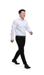Businessman in formal clothes walking on white background