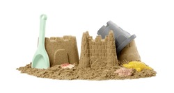Beautiful sand castles, shells and plastic beach toys isolated on white