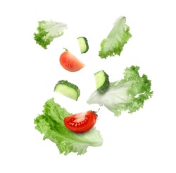 Lettuce leaves, cut cucumber and tomato falling on white background