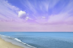 Fantastic blue pink sky over ocean and sandy beach