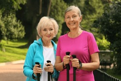Senior women with Nordic walking poles outdoors