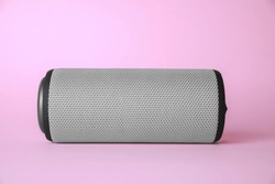 One portable bluetooth speaker on pink background. Audio equipment