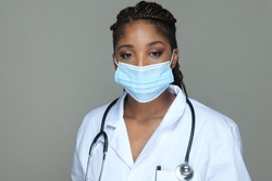 Portrait of an African American  doctor in white robe and face mask