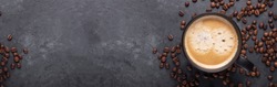 Horizontal banner with cup of coffee and coffee beans on dark stone background. Top view. Copy space - Image