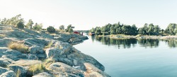 Red wooden house in lake landscape in Sweden, forest, panorama in summer, Norrmalm, Sundsvall, Gothenburg, Gotland