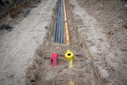 Pipes and barrier tape for gas pipe and fiber optic in construction site. 