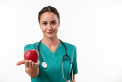 Young woman medical doctor with apple
