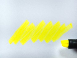 yellow line on paper, yellow highlighter on white paper background.