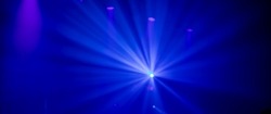 Background in show concert with blue beam spotlights. It is a striped gradient background in the concert.