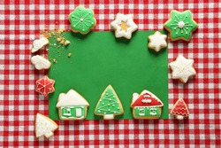 Frame made of Christmas cookies on color background, top view