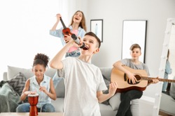 Teenage musicians playing and singing at home