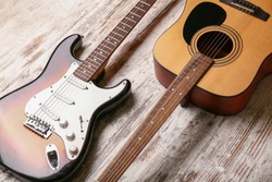 Modern guitars on wooden background