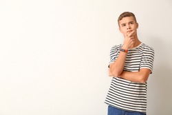 Thoughtful teenage boy on white background