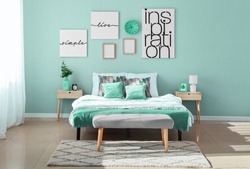 Stylish interior of bedroom in turquoise color