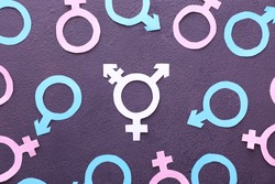 Symbols of man, woman and transgender on dark background