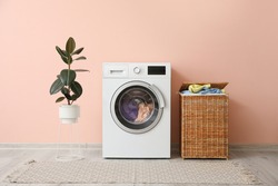 Washing machine and basket with laundry near color wall