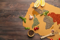 World map made of different spices on wooden background