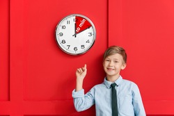 Little boy near clock with timer for 10 minutes on color background. Time management concept