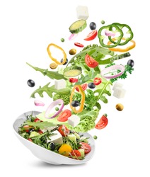 Bowl with healthy salad and flying ingredients on white background