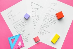 Papers with mathematical formulas on color background