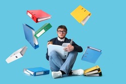 Man with many folders on color background