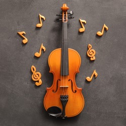 Violin with music notes on dark background