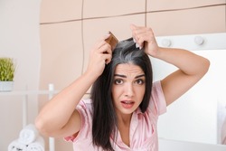 Stressed woman with graying hair at home