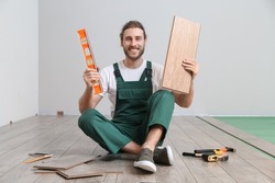 Carpenter with laminate sample and ruler in room