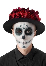 Young man with painted skull on his face against white background. Celebration of Mexico's Day of the Dead (El Dia de Muertos)