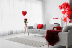 Interior of living room with sofa and decor for Valentine's Day