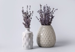 Vases with beautiful lavender flowers on grey background