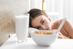 Food on table in bedroom of young woman. Anorexia concept