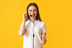 Female technical support agent showing thumb-up on color background