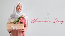 Beautiful greeting card for International Women's Day celebration with young Muslim woman holding gift