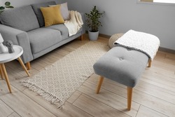 Soft bench with plaid in interior of light living room