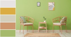Comfortable wicker chairs and stepladder stool near green wall in room. Different color patterns