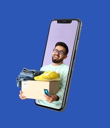 Happy young man with parcel looking out of smartphone screen on blue background. Online shopping concept