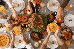 Happy family having dinner at festive table on Thanksgiving Day, top view