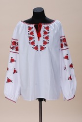 White embroidery with large flowers. Vyshyvanka Ukrainian folk costume. Vyshyvanka ornament large red roses