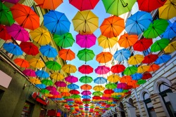 Colorful umbrellas hanging out above the old streets of Timisoara city center, Romania. Photo taken on 21st of April 2019.