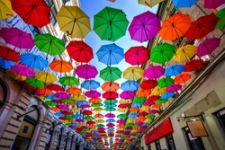 Colorful umbrellas hanging out above the old streets of Timisoara city center, Romania. Photo taken on 21st of April 2019.