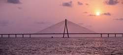 sunset near mumbai worli bandra sea link bridge and small boat in ocean