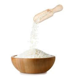 uncooked jasmine rice falling from scoop in wooden bowl isolated on white background