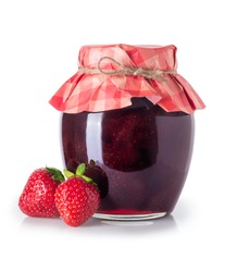 Glass jar of strawberry jam and fresh berries near isolated on white background. Preserved fruits