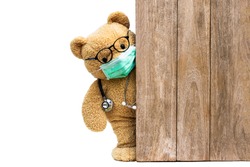 Brown teddy bear doctor with protective medical facemask and stethoscope. Quarantine coronavirus pandemic protection,  covid concept.