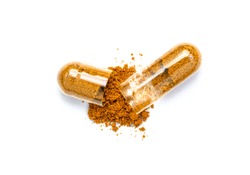 Turmeric herbal powder capsules isolated on white background. Top view. Flat lay.