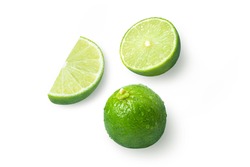 Lime fruits and cut in half slice isolated on white background. Top view. Flat lay.