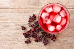 Hibiscus ice tea (roselle juice) and dry jamaica flower isolated on white background. Top view. Flat lay. Copy space.