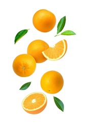 Orange fruit with cut half sliced and green leaf flying in the air isolated on white background.